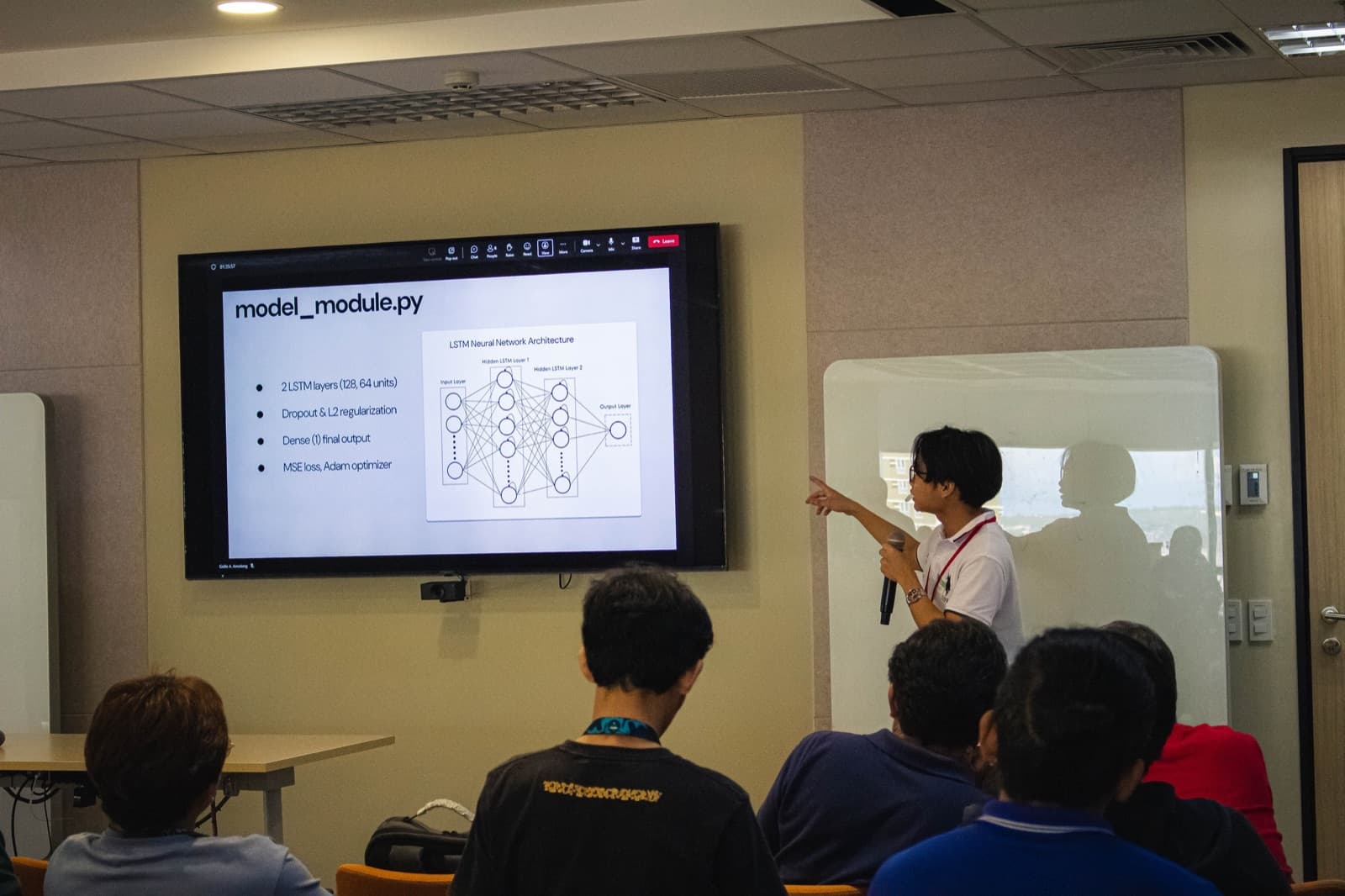 Gaille presenting an LSTM neural network architecture slide to a full room
