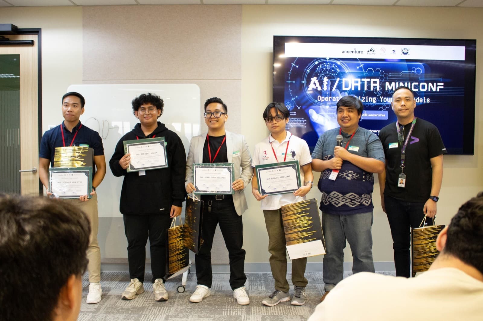 Gaille with fellow speakers holding certificates at the Accenture-hosted conference